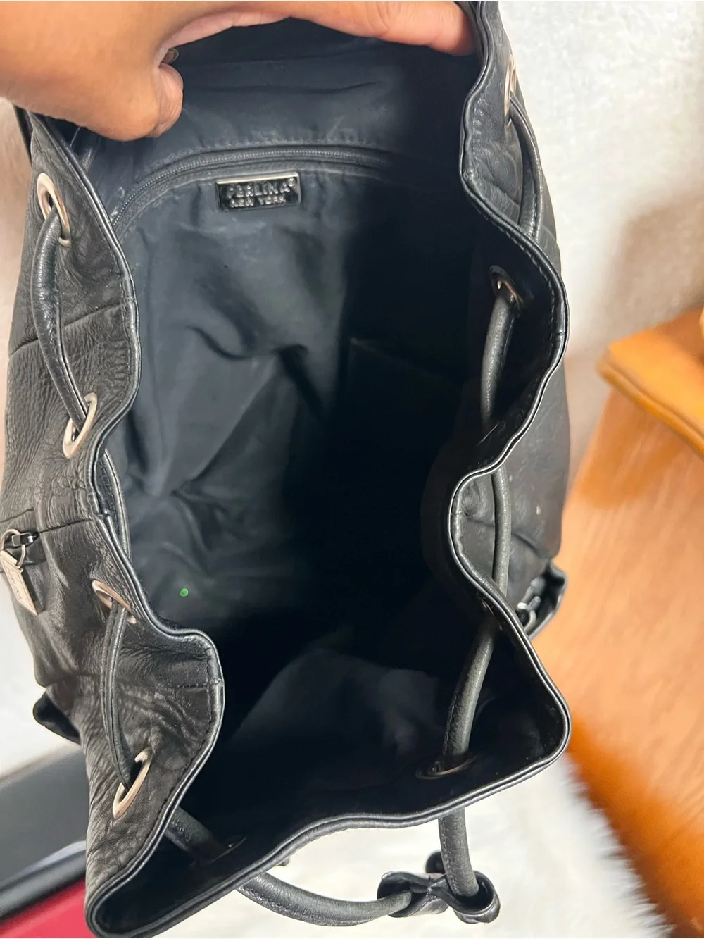 Perlina Black Leather Drawstring Flap Backpack